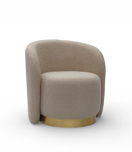 Angled front view of the Vaya Home Cocoon accent chair with beige boucle upholstery, curved silhouette, and gold base detail.