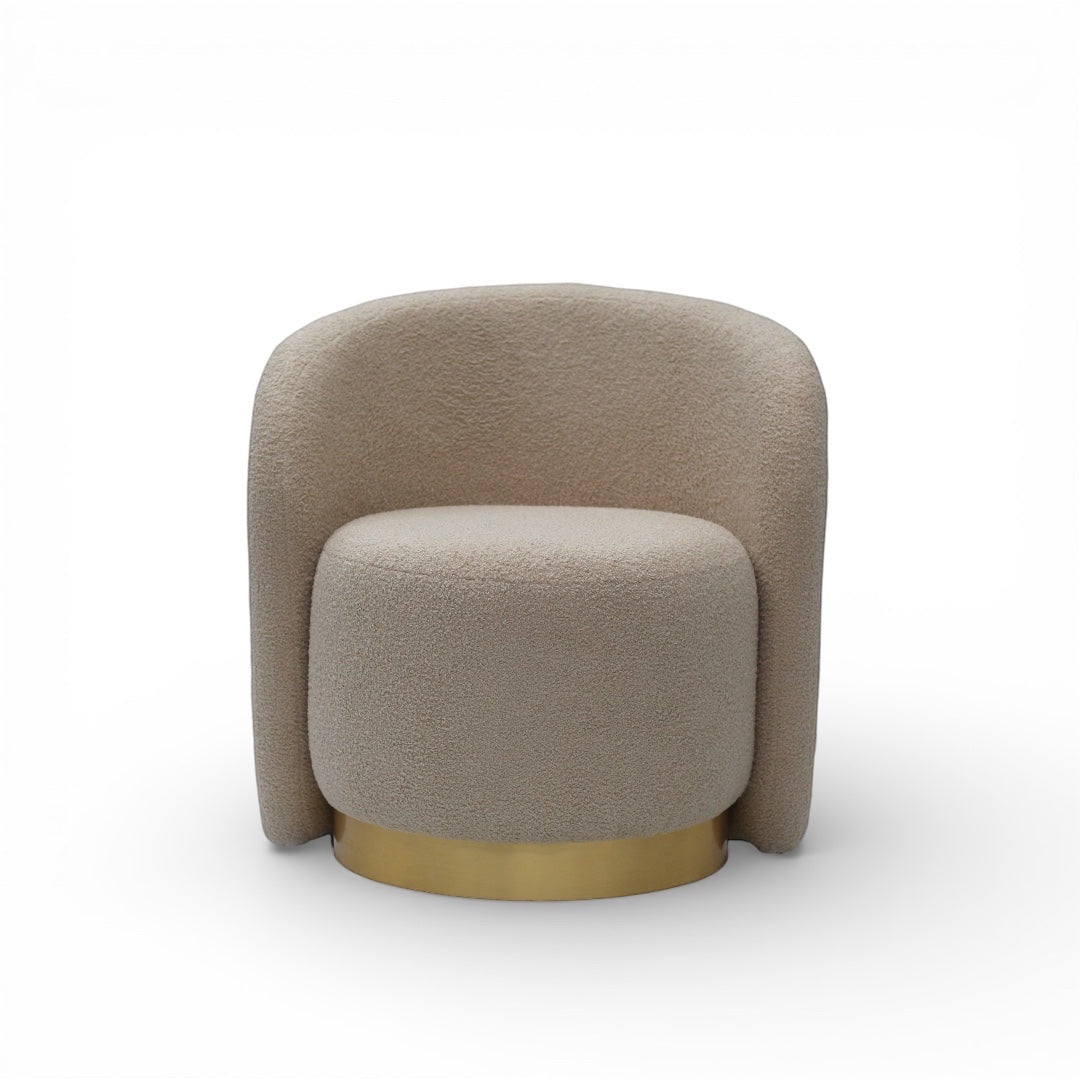 Front view of the Vaya Home Cocoon accent chair with beige boucle upholstery, rounded backrest, and gold base detail.