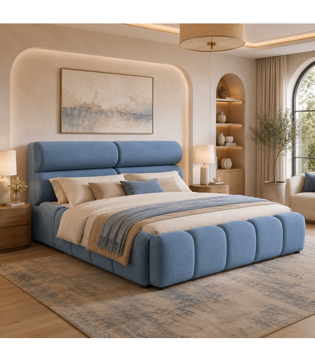 Vaya Home Como upholstered platform bed in blue with a padded headboard and channel-detailed base, styled in a modern bedroom.