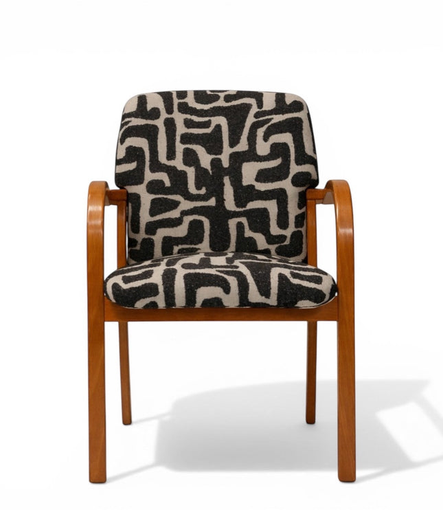 Front view of the Vaya Home Contour accent chair with curved wood frame and black-and-cream abstract patterned seat and back upholstery.
