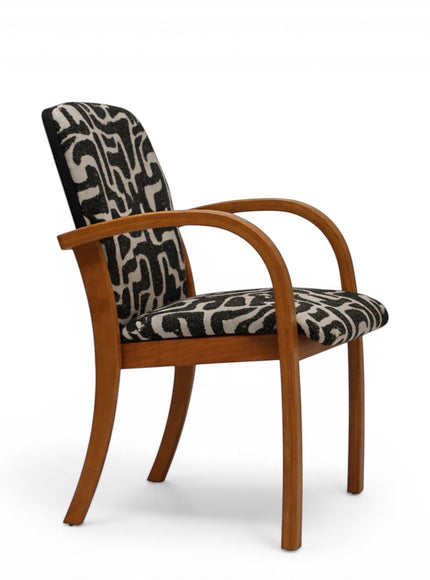 Side view of the Vaya Home Contour accent chair showing curved wood arms, upholstered seat, and abstract black-and-cream patterned backrest.