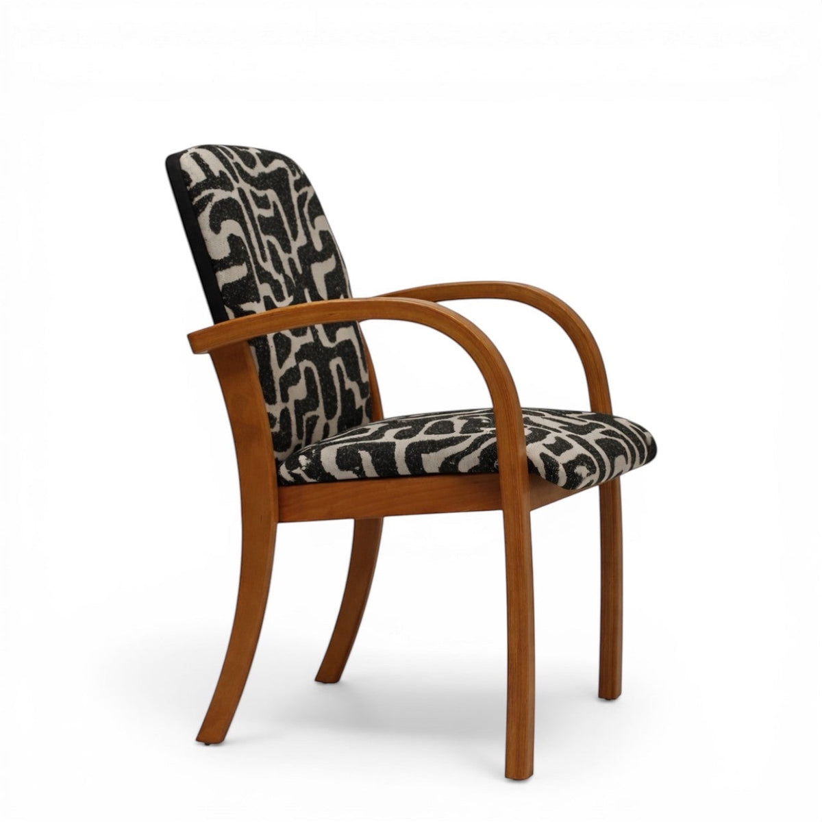 Side view of the Vaya Home Contour accent chair showing curved wood arms, upholstered seat, and abstract black-and-cream patterned backrest.