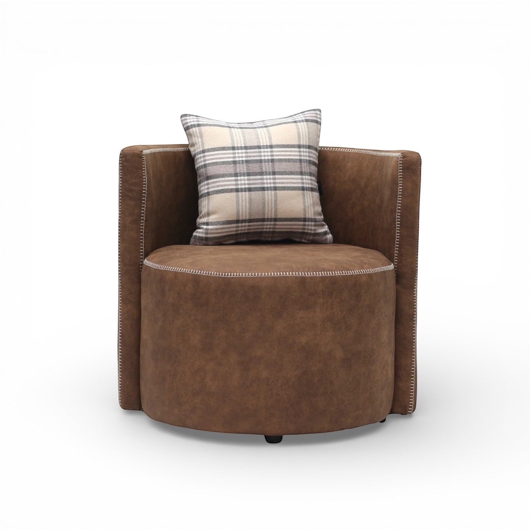 Front view of the Vaya Home Corvyn brown leather armchair with a rounded seat, curved back, and plaid accent cushion.
