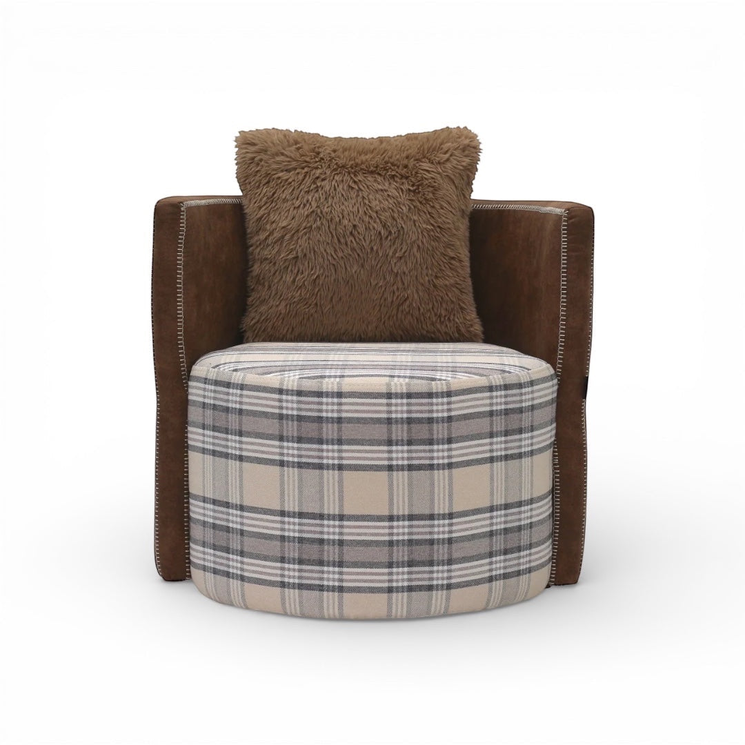 Front view of the Vaya Home Corvyn armchair with a checkered upholstered seat, brown leather frame, and textured accent cushion.