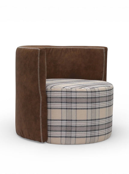 Side angled view of the Vaya Home Corvyn armchair showing a checkered upholstered seat and curved brown leather outer frame.
