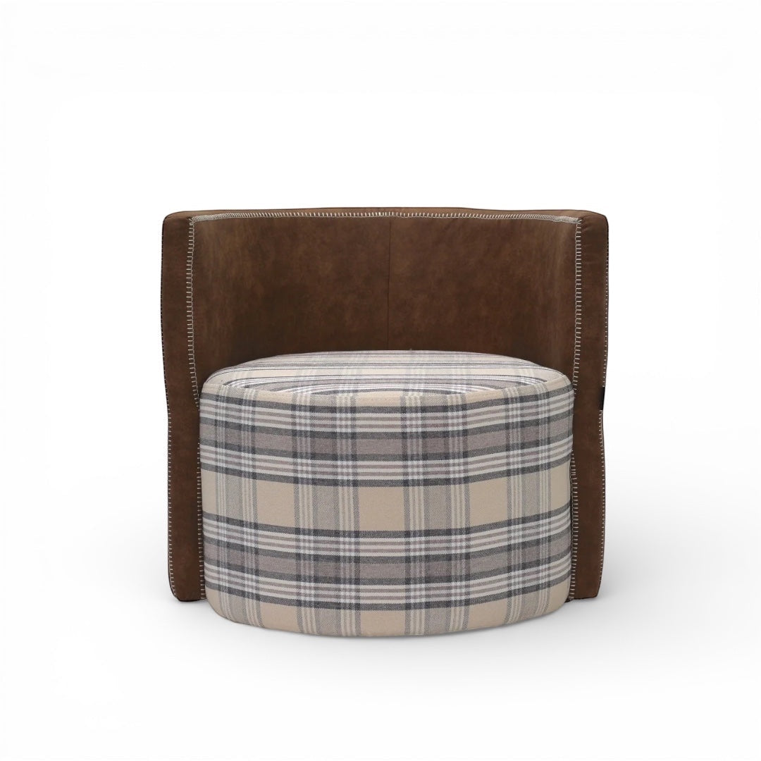 Front view of the Vaya Home Corvyn armchair with a checkered upholstered seat and curved brown leather outer frame.