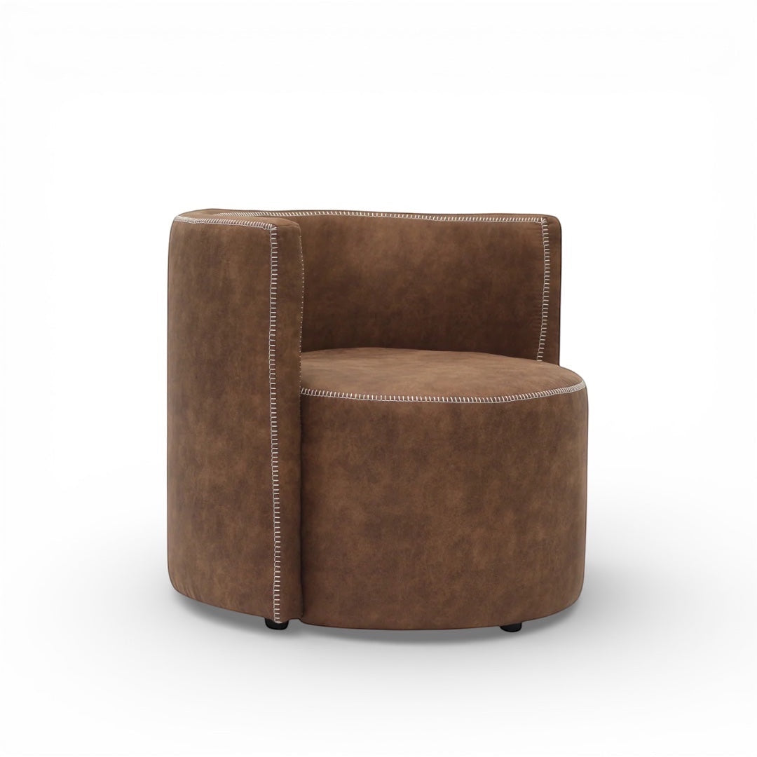 Side angled view of the Vaya Home Corvyn armchair with brown leather upholstery, rounded seat, and curved backrest.