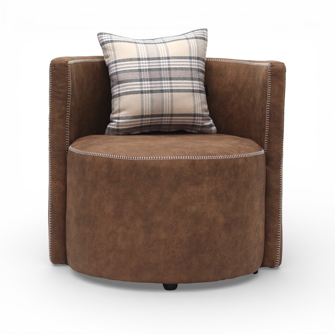 Front view of the Vaya Home Corvyn brown leather armchair with a rounded seat, curved back, and plaid accent cushion.