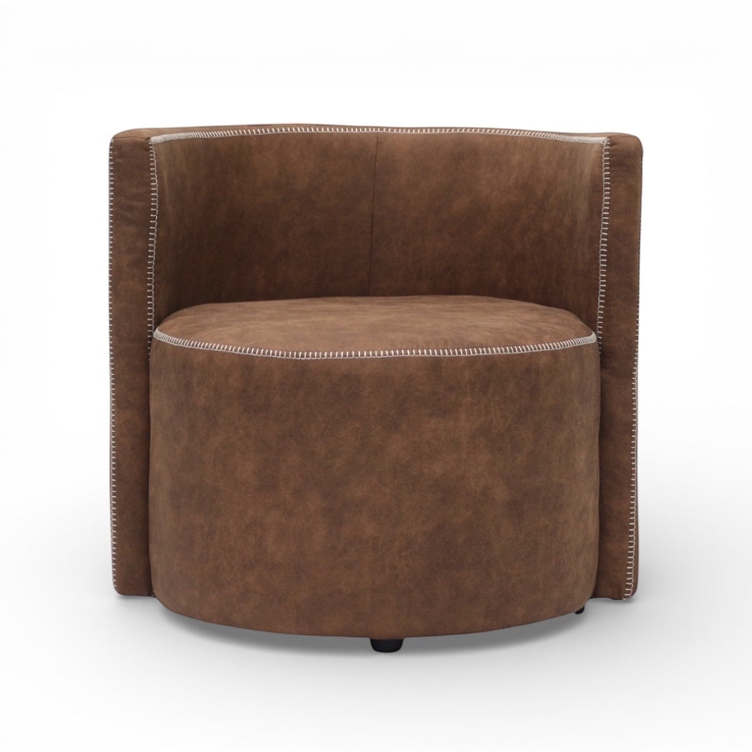 Front view of the Vaya Home Corvyn brown leather armchair featuring a rounded seat, curved backrest, and brown leather upholstery.