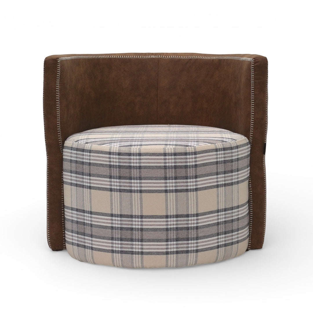 Front view of the Vaya Home Corvyn checkered armchair featuring a plaid upholstered seat, curved backrest, and brown leather outer frame.