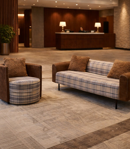 Vaya Home Corvyn checkered armchair styled in a modern lounge setting beside the matching Corvyn sofa.