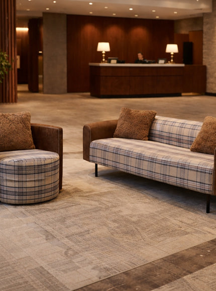 Vaya Home Corvyn checkered armchair styled in a modern lounge setting beside the matching Corvyn sofa.