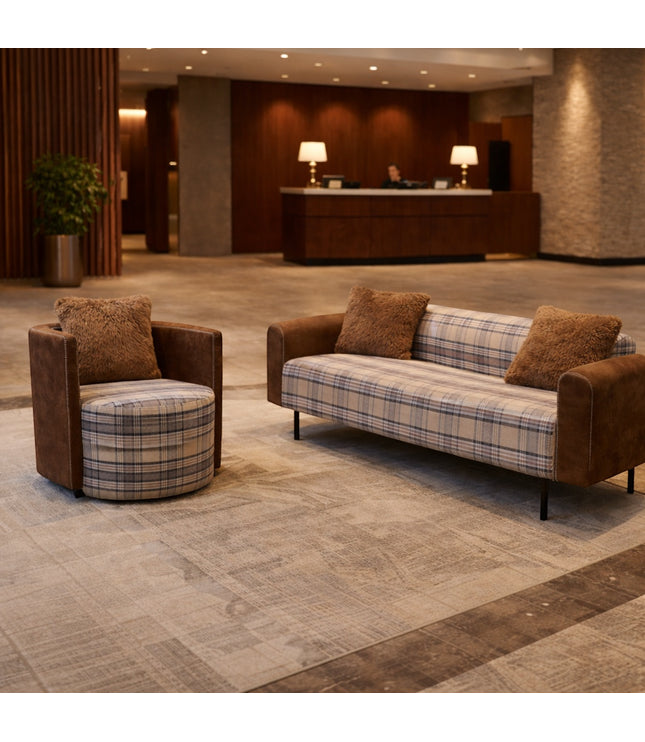 Vaya Home Corvyn checkered armchair styled in a modern lounge setting beside the matching Corvyn sofa.