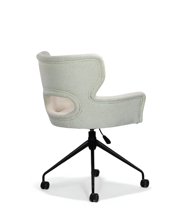 Side angled view of the Vaya Home Crespo swivel office chair with white upholstery, sculpted cutout backrest, and black rolling base.