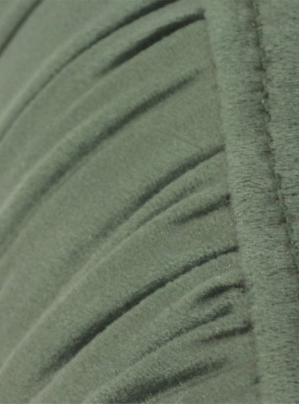 Close-up of the Vaya Home Cushion accent chair showing green velvet upholstery and channel-tufted detail.