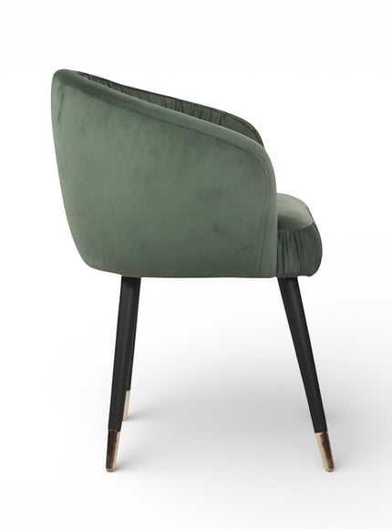 Opposite side view of the Vaya Home Cushion accent chair with green velvet upholstery and black legs with gold caps.