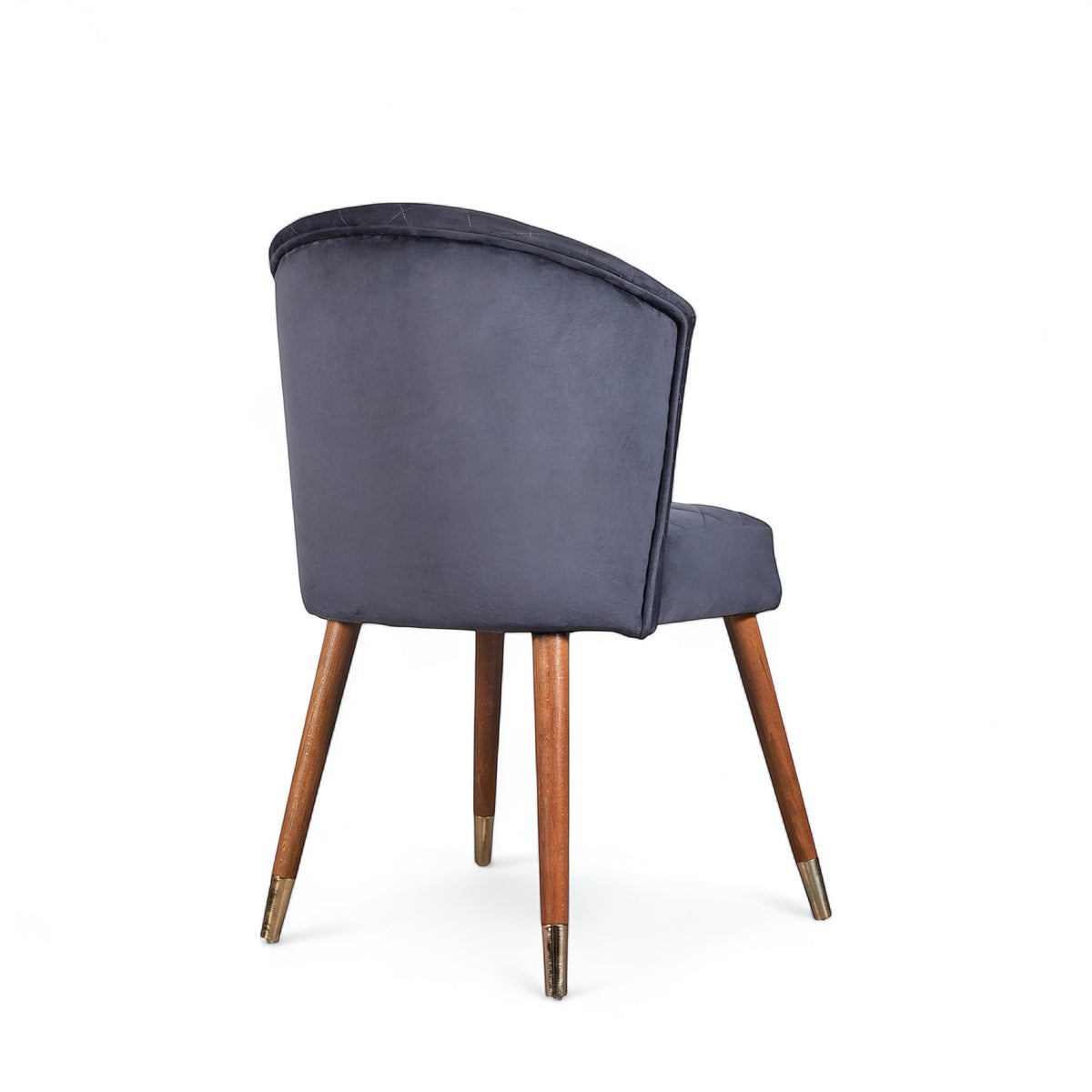 Rear angled view of the Vaya Home Diamante dining chair featuring dark blue upholstery and tapered wood legs.