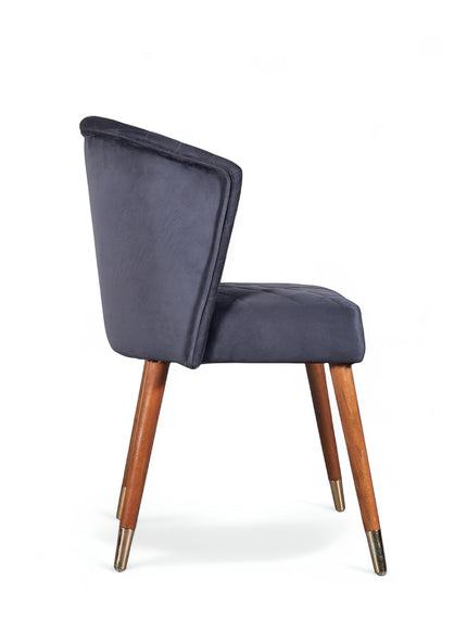 Side view of the Vaya Home Diamante dining chair with dark blue upholstery and tapered wood legs.