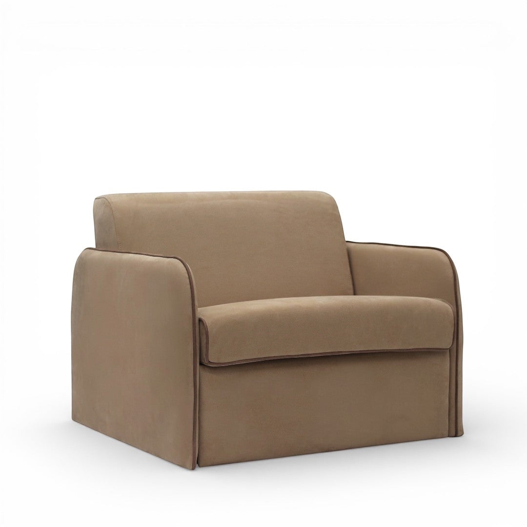 Angled view of the Vaya Home Eira sleeper chair with beige upholstery, wide arms, and a compact modern silhouette.