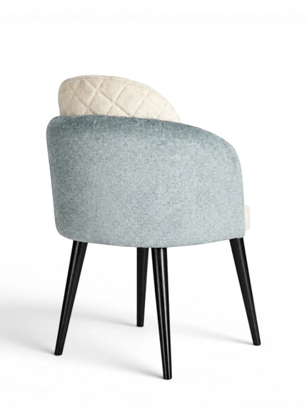 Back view of the Vaya Home Elowen dining chair featuring a blue upholstered outer back, cream inner upholstery, and black legs.