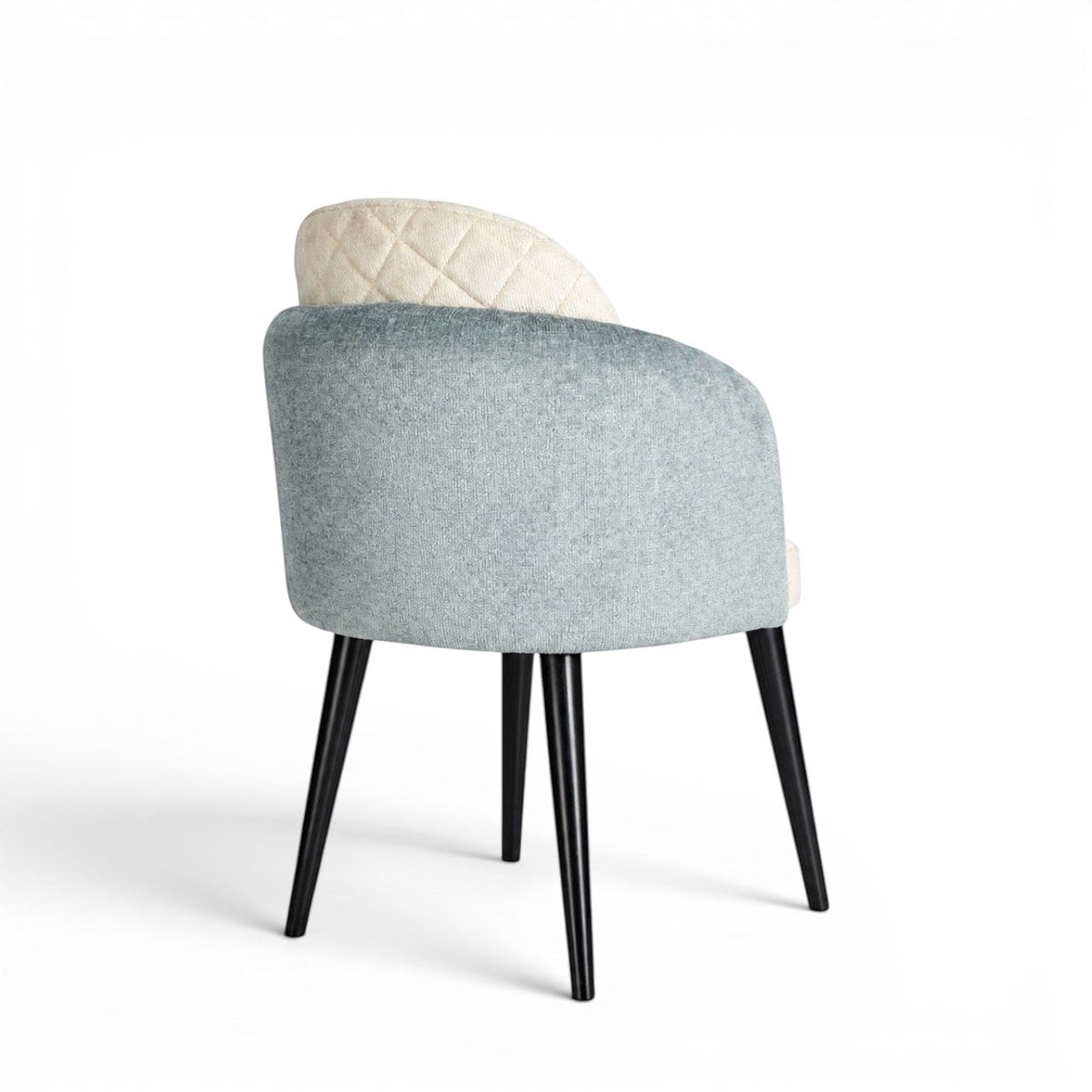 Back view of the Vaya Home Elowen dining chair featuring a blue upholstered outer back, cream inner upholstery, and black legs.