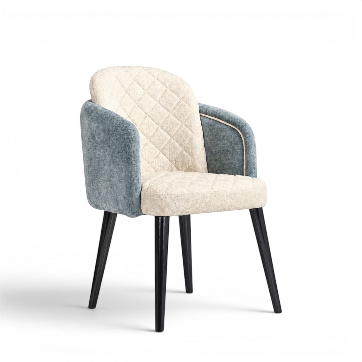 Front angled view of the Vaya Home Elowen dining chair with a cream diamond-tufted inner back, blue upholstered outer back and arms, and black legs.
