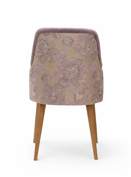 Back view of the Vaya Home Flora dining chair featuring a floral patterned fabric back panel and tapered wood legs.