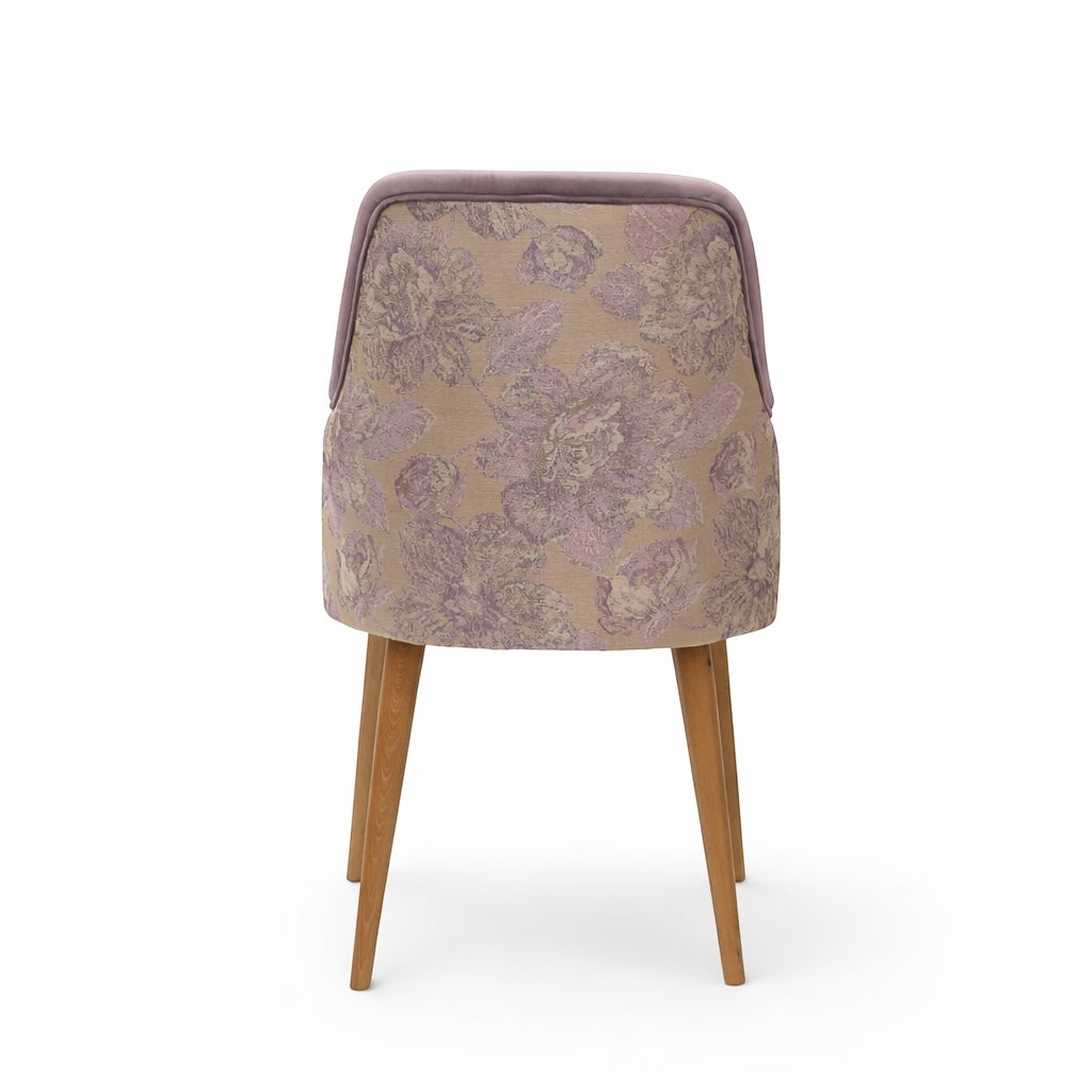 Back view of the Vaya Home Flora dining chair featuring a floral patterned fabric back panel and tapered wood legs.