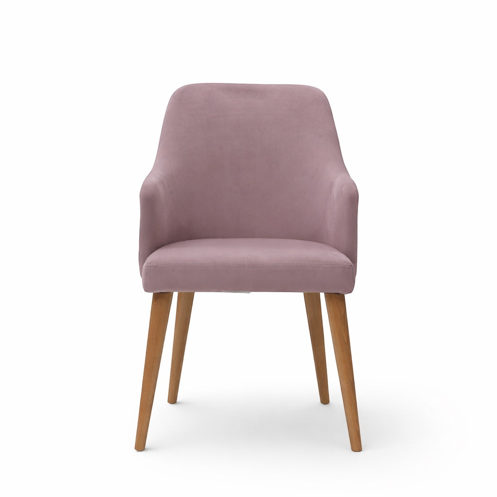 Front view of the Vaya Home Flora dining chair with lilac upholstery, softly curved arms, and tapered wood legs.