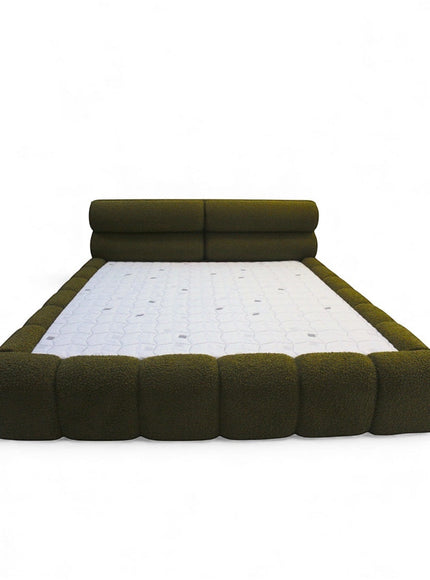 Front view of the Vaya Home Forma bed featuring olive green upholstery, a low-profile silhouette, and padded channel-style frame detailing.