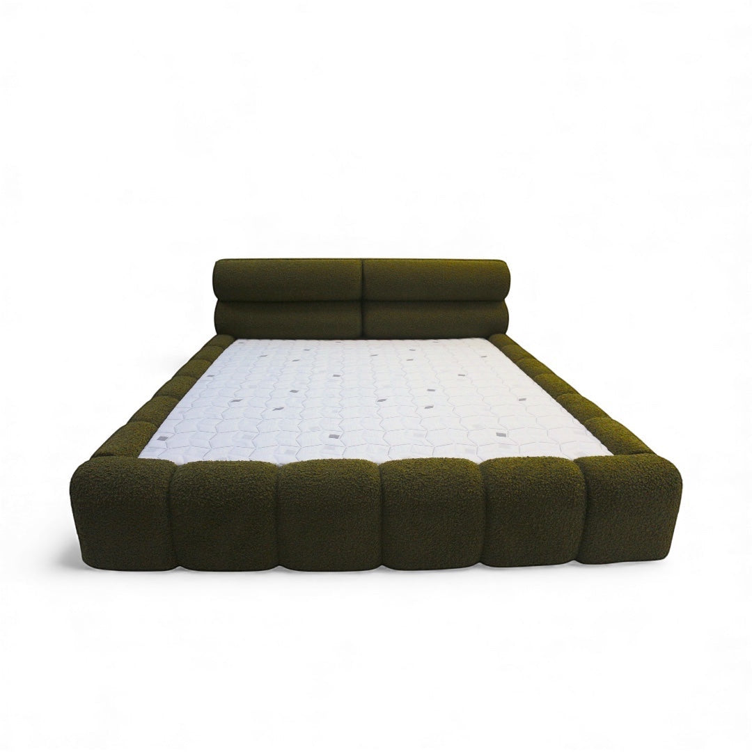 Front view of the Vaya Home Forma bed featuring olive green upholstery, a low-profile silhouette, and padded channel-style frame detailing.