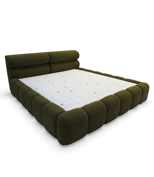 Angled front view of the Vaya Home Forma bed with olive green upholstery, low-profile frame, and padded channel-style side detailing.