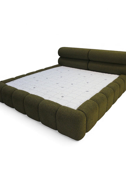 Side angled view of the Vaya Home Forma bed with olive green upholstery and sculpted padded frame detail.