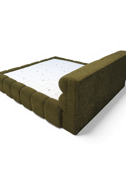 Rear angled view of the Vaya Home Forma bed showing the upholstered headboard and padded olive green frame.