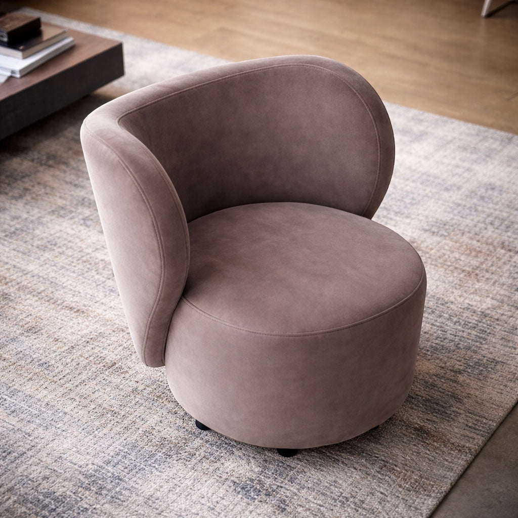 Angled view of the Vaya Home Halo accent chair with taupe upholstery, rounded seat, and sculptural curved backrest.