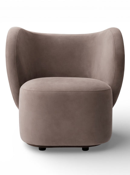 Front view of the Vaya Home Halo accent chair featuring a rounded upholstered seat and curved wraparound backrest in taupe fabric.