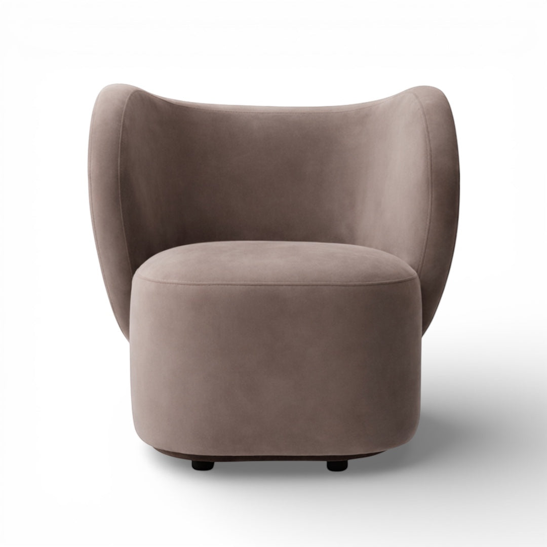 Front view of the Vaya Home Halo accent chair featuring a rounded upholstered seat and curved wraparound backrest in taupe fabric.