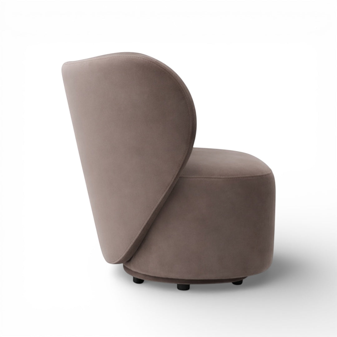 Profile view of the Vaya Home Halo accent chair with a rounded seat base and sweeping curved backrest in taupe upholstery.