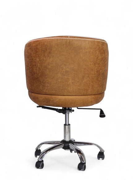 Back view of the Vaya Home Hugo swivel office chair featuring brown faux leather upholstery and a chrome rolling base.