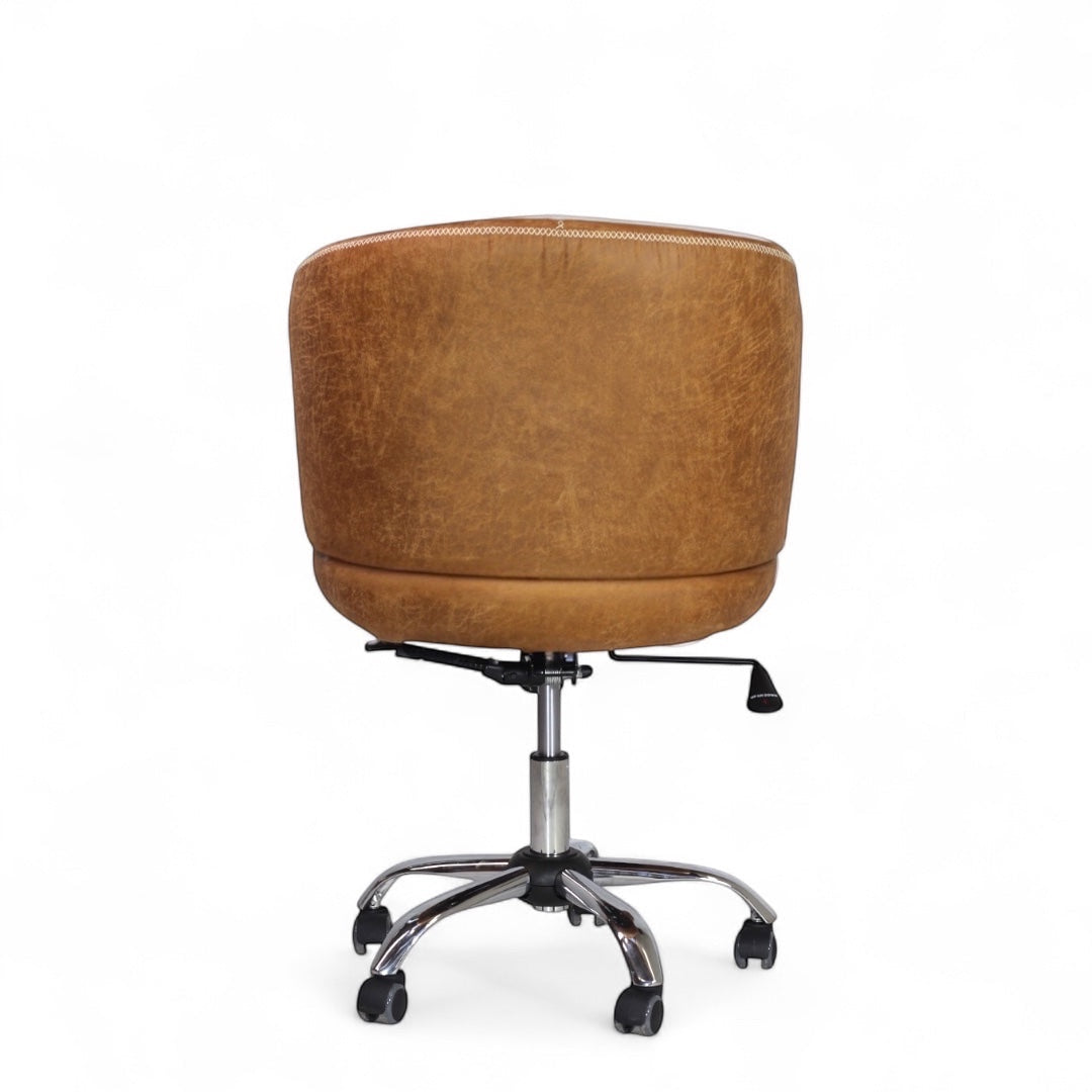 Back view of the Vaya Home Hugo swivel office chair featuring brown faux leather upholstery and a chrome rolling base.