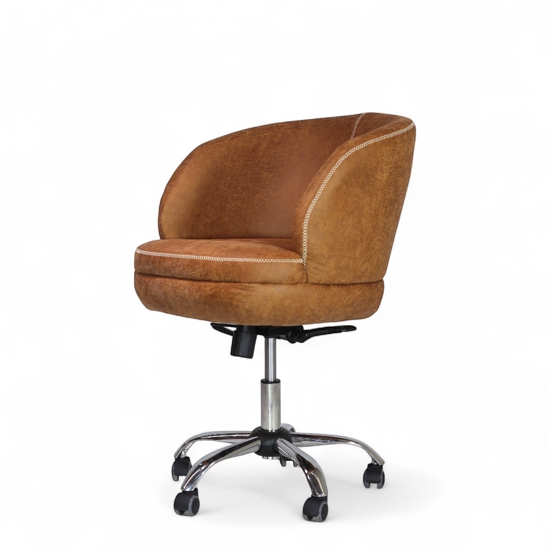 Side angled view of the Vaya Home Hugo swivel office chair with brown faux leather upholstery, rounded backrest, and chrome caster base.