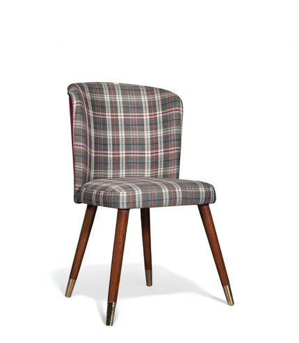 Front angled view of the Vaya Home Inverto dining chair with checkered upholstery, curved backrest, and tapered wood legs with gold caps.