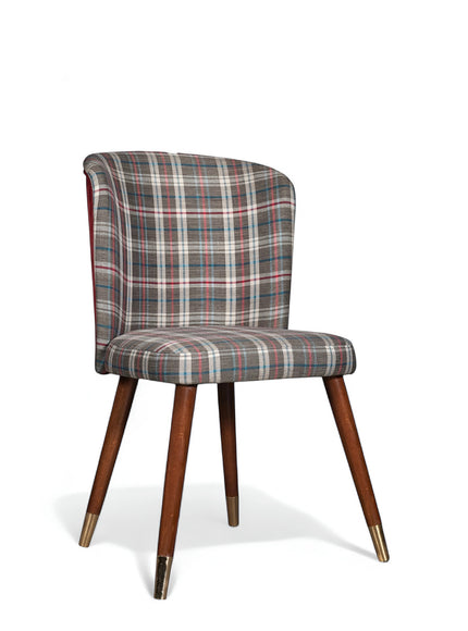 Front angled view of the Vaya Home Inverto dining chair with checkered upholstery, curved backrest, and tapered wood legs with gold caps.