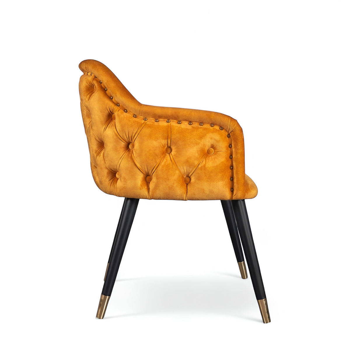 Product view of the Vaya Home Lila accent chair in dark blue velvet upholstery with nailhead trim and black legs with gold caps.
