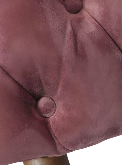 Close-up of the Vaya Home Lila accent chair showing pink velvet upholstery and button-tufted detail.