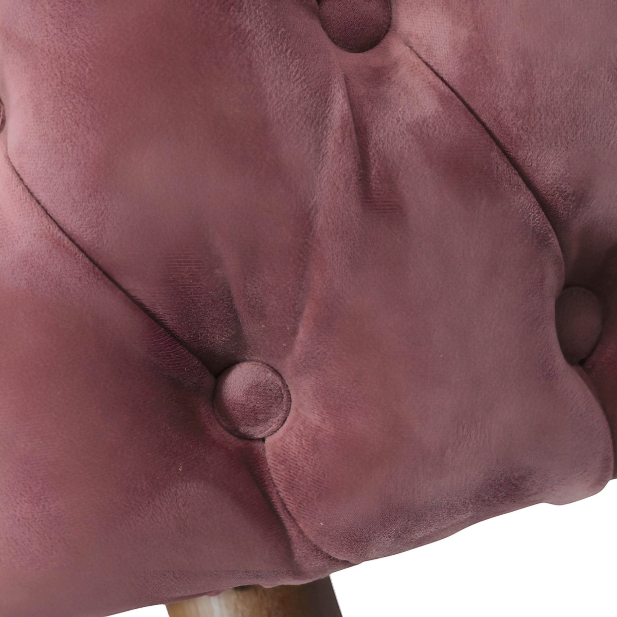 Close-up of the Vaya Home Lila accent chair showing pink velvet upholstery and button-tufted detail.