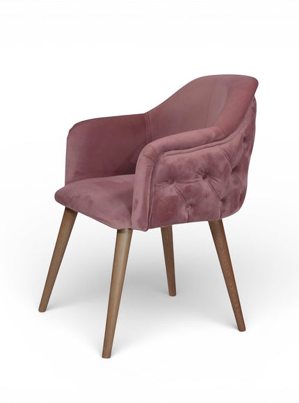 Front view of the Vaya Home Lila accent chair featuring pink velvet upholstery, a cushioned seat, and tapered wood legs.