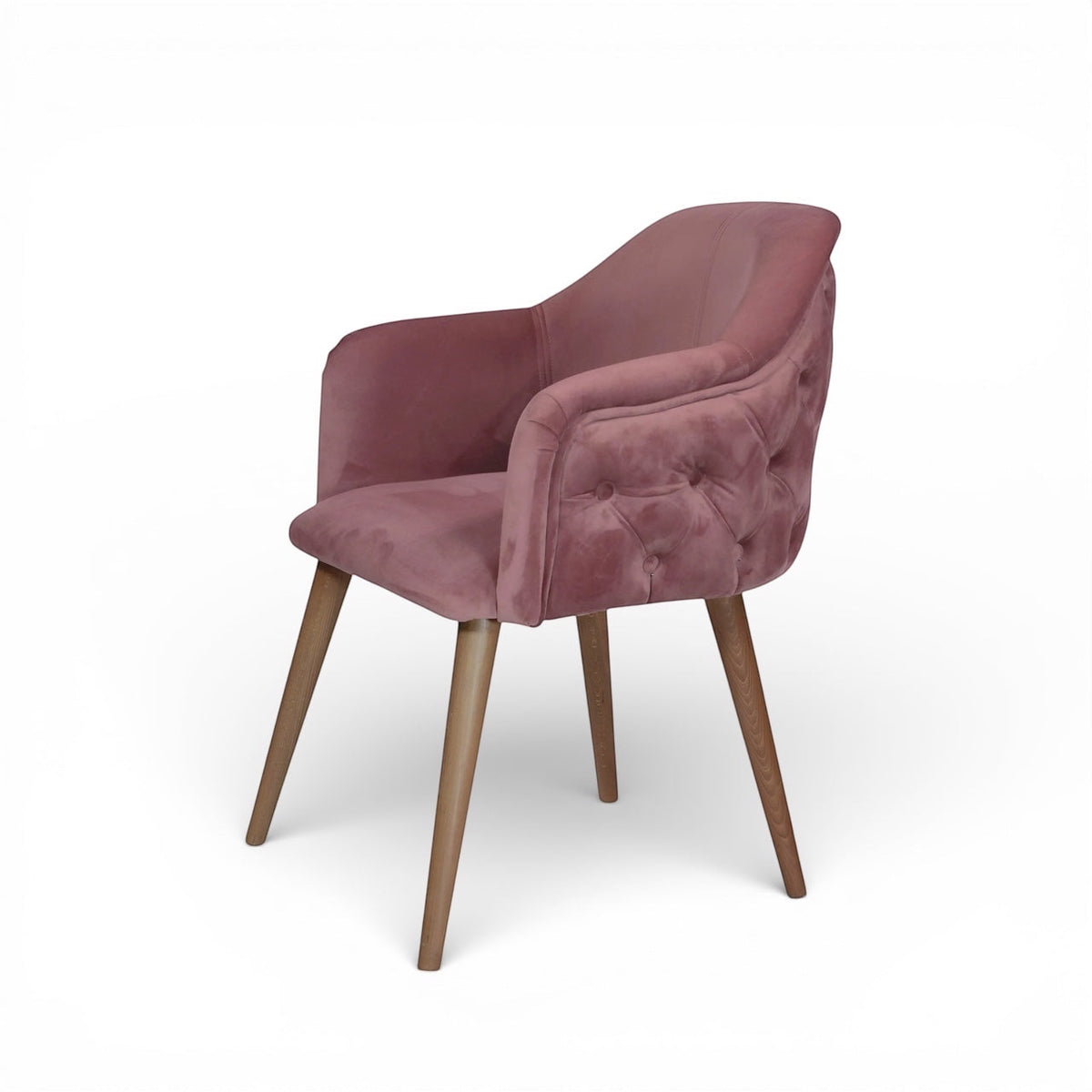 Front view of the Vaya Home Lila accent chair featuring pink velvet upholstery, a cushioned seat, and tapered wood legs.