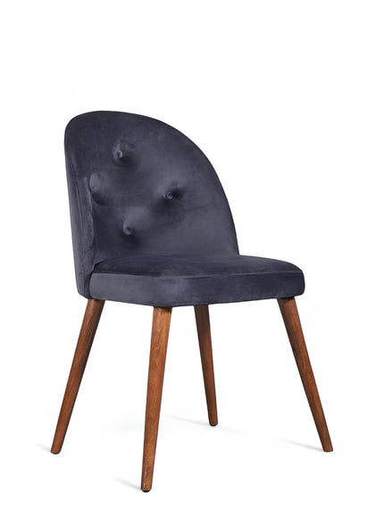 Back view of the Vaya Home Limett dining chair with beige upholstery and tapered wood legs.