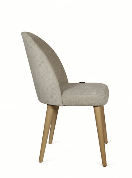 Back view of the Vaya Home Limett dining chair featuring dark blue upholstery and tapered wood legs.